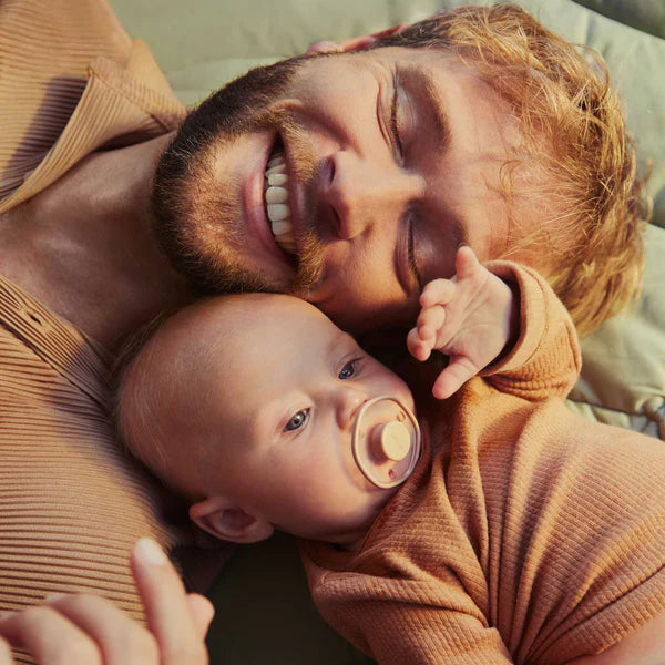 Father feeding baby with bottle